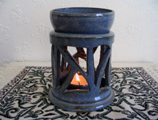 Blue Ceramic Essential Oil Burner with lit candle